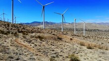 Windmills, Wind Turbines Aerial 4k Drone Boom Up And Rise, Energy, Green, Renewable, Huge Power Generating Farm,  With Mt. San Gorgonio In BG In Palm Springs, Coachella Valley, Cabazon, Calif., Desert
