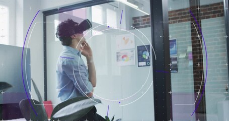 Poster - Animation of purple light trails with hexagons over businessman wearing vr headset in office