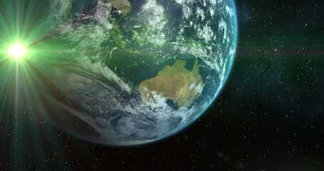 animation of planet earth in universe and green glowing star seen from space