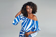 Beautiful african american model with afro hair isolated on gray