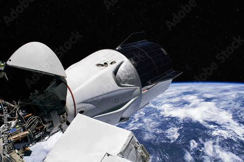 The SpaceX Crew Dragon spacecraft is docked to the International Space Station. Elements of this image furnished by NASA