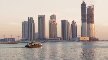 Wall Mural - Dubai, UAE - 04.17.2021 Traditional Emirati boat called abra sailing trough creek in front of Dubai Creek Harbour. Outdoors