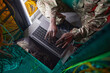 © Seventyfour - Cropped high angle portrait of young African-American woman wearing military uniform while using computer in server room