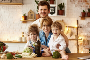 Wall Mural - happy family with their children cooking in the kitchen