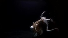 Female Corpse Is Sinking Inside Sea Or River, Underwater Shot Of Woman Figure In Darkness And Deepness