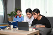 © Prathankarnpap - Young asian girl sitting on sofa in living room using computer tablet and enjoy leisure weekend together.