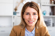 © JackF - positive woman sitting and smiling in white room