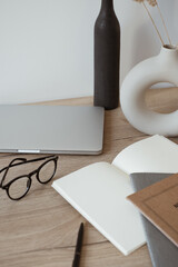 Wall Mural - Home office desk workspace with laptop, notebook, glasses on wooden background. Aesthetic blog, web, social media concept.
