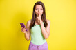 © deagreez - Photo of excited gossip girl hold telephone forefinger cover lips wear green top isolated yellow color background