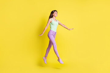 Poster - Profile photo of girlish pretty lady go run empty space wear green top trousers sneakers isolated yellow color background