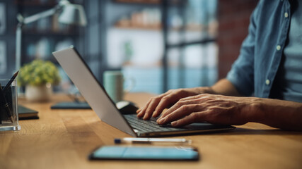 Aufkleber - Close Up on Hands of a Male Specialist Working on Laptop Computer at Cozy Home Living Room while Sitting at a Table. Freelancer Man Chatting Over the Internet on Social Networks.