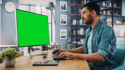 Aufkleber - Handsome Caucasian Specialist Working on Desktop Computer with Green Screen Mock Up Display at Home Living Room. Freelance Man Chatting to Clients Over the Internet on Social Networks.
