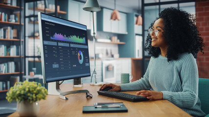 Aufkleber - Latina Female Specialist Working on Desktop Computer at Home Living Room while Sitting at a Table.  Freelance Female is Doing Market Analysis and Creates Report with Charts for Clients and Employer.
