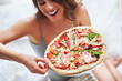 © Kalim - Beautiful adult woman eating pizza at home