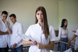 © liderina - Time for checking a patient.  Medical students in patient room. Focus is on foreground.