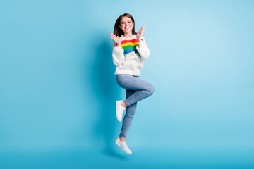 Poster - Full length photo of impressed pretty young woman dressed striped sweater jumping high rising arms isolated blue color background