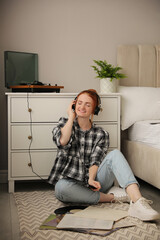 Poster - Young woman listening to music with turntable in bedroom