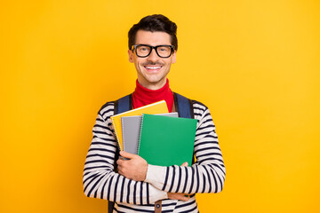 Sticker - Portrait of satisfied person hands hold copybooks carry rucksack beaming smile isolated on yellow color background