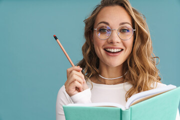 Smiling young woman in glasses holding pencil