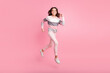 © deagreez - Full length photo of little beautiful young girl jump up run sale hurry isolated on pink color background