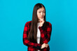 © luismolinero - Young Chinese girl over isolated blue background and thinking