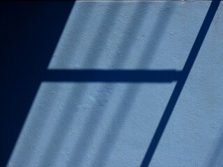 Canvas Print - abstract shadow of window on blue wall background