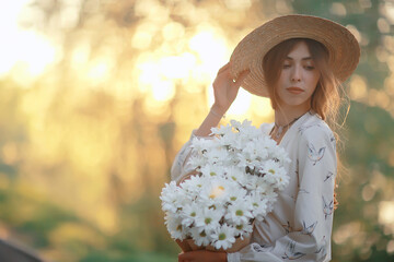 Wall Mural - happy girl with flowers in the city / summer photo young beautiful girl holding a bouquet of flowers