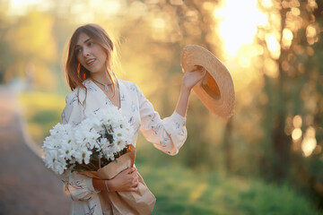 Wall Mural - girl in a straw hat portrait spring freedom / concept spring view model happy people