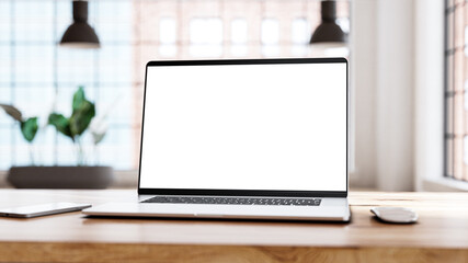 Laptop blank white screen in office loft interior.