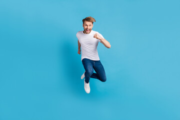 Sticker - Full body of active carefree person rush toothy smile look camera isolated on blue color background