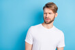 © deagreez - Portrait of unsatisfied man look interested empty space sullen eyebrows lips isolated on blue color background