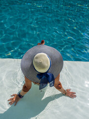 Wall Mural - woman in luxury spa resort near the swimming pool.