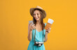 © Prostock-studio - Woman in summer hat with passport using smartphone