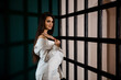 © Nina_Arnis - Fashion portrait of pretty sexy young brunette woman in white pantsuit
