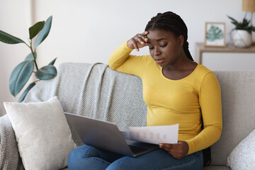 Aufkleber - Remote Business. African woman checking papers and working with laptop at home
