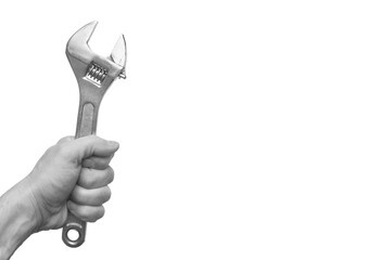 Wall Mural - wrench in hand. set of tools. metal tool in a fist. device in the palm. the master holds an adjustable wrench