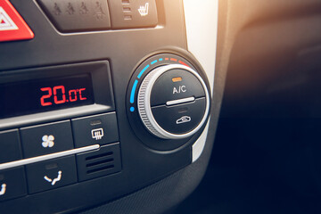 Switcher of air conditioning in the car. Button to turning on car climate control system. Close up view with selective focus.