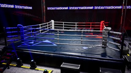 Wall Mural - Empty boxing arena in the light of a spotlight 4k video. High quality 4k footage