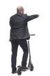 © ASDF - rear view . Mature man leaving on an electric scooter