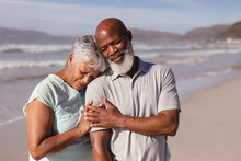Happy Senior African American Couple Embracing Each Other On The Beach