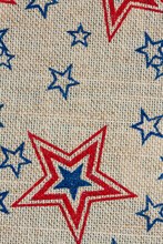 Red And Blue Stars On Burlap Background