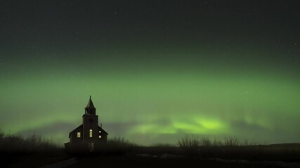 Wall Mural - aurora arc and move across the sky above an abandoned dilapidated large church with light coming thr