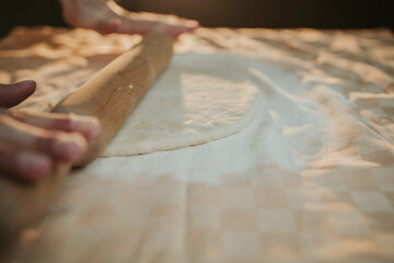 Wall Mural - Person preparing a dough with a rolling pin