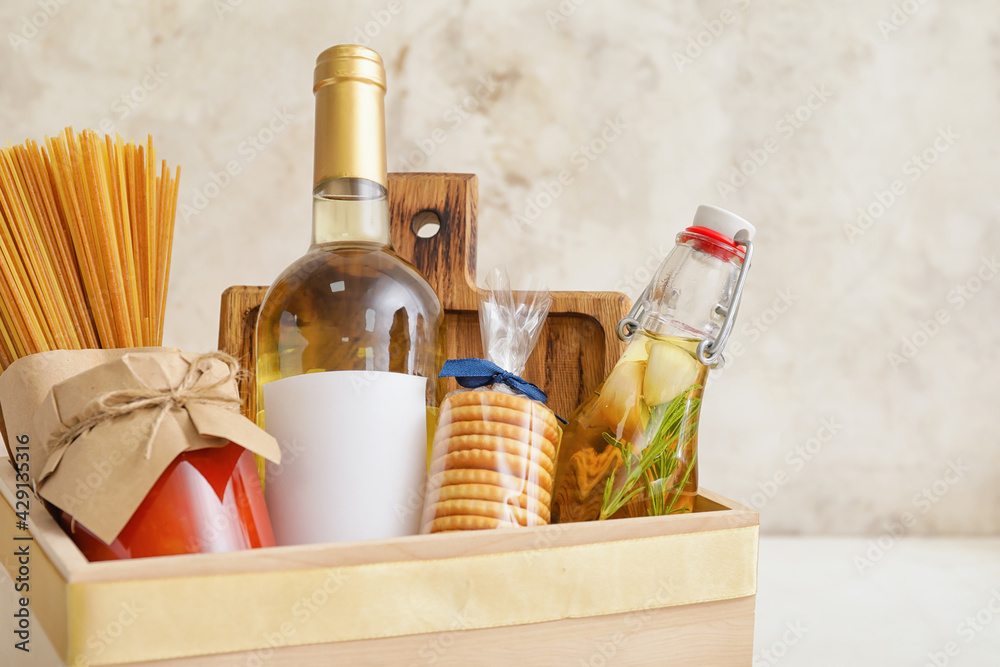 Gift basket with products on light background, closeup