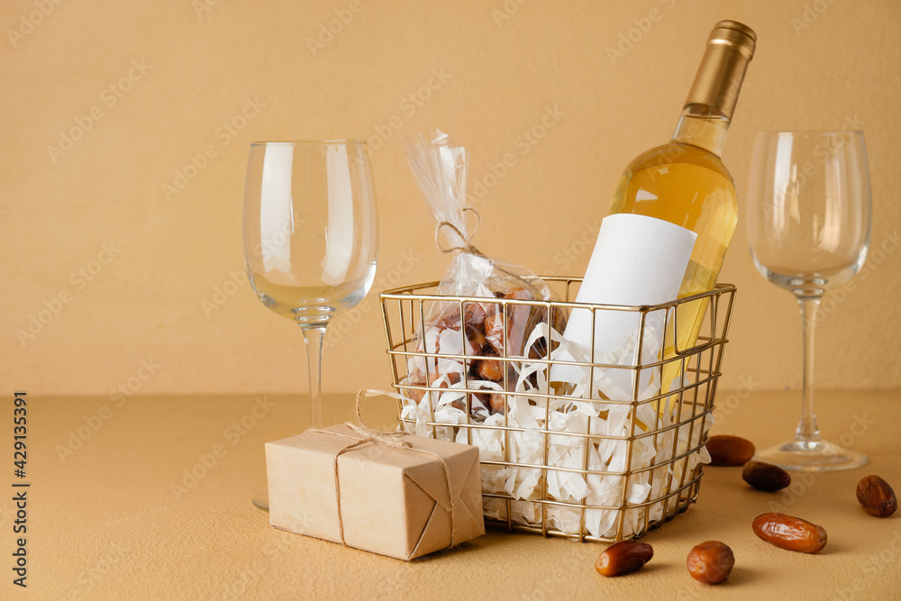 Gift basket with products on color background