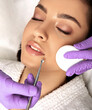 © Peakstock - Facial cleansing. Beautiful woman having mechanical cleansing face skin from defect and remove blackhead, high quality