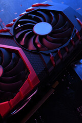 Poster - Computer game graphics card, videocard with two coolers on circuit board ,motherboard background. Close-up. With red-blue lighting