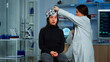 © DC Studio - Doctor researcher adjusting EEG headset analyzing patient's evolution after treatment against disease of nervous system. Team of scientists working late night in neurological research laboratory