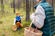© Syda Productions - picking season, leisure and people concept - happy smiling grandmother and grandson with baskets and mushrooms in forest
