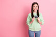 © deagreez - Photo of optimistic sweet brunette girl show card look empty space wear lime shirt jeans isolated on pink color background
